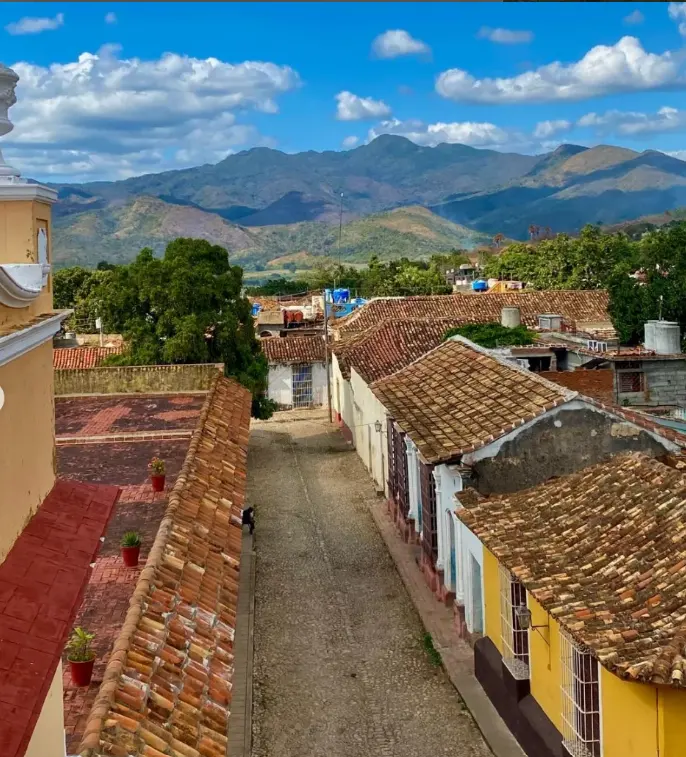 The roofs and a cobbled street in Trinidad, with the Escambray mountains behind